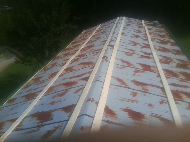 Rusted metal roof panels with new wood purlins before replacement — Storm Damage Roof Repair in Willow Street by Roofing Brothers